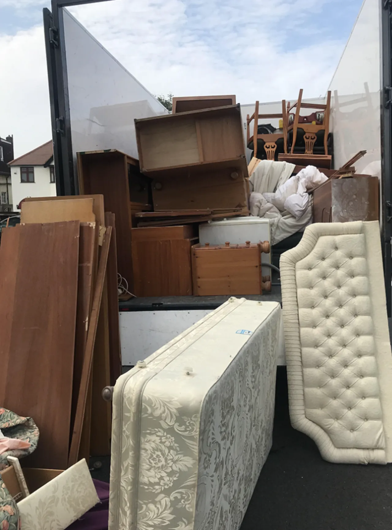 Old mattresses and furniture loaded for junk removal by AKA Moving
